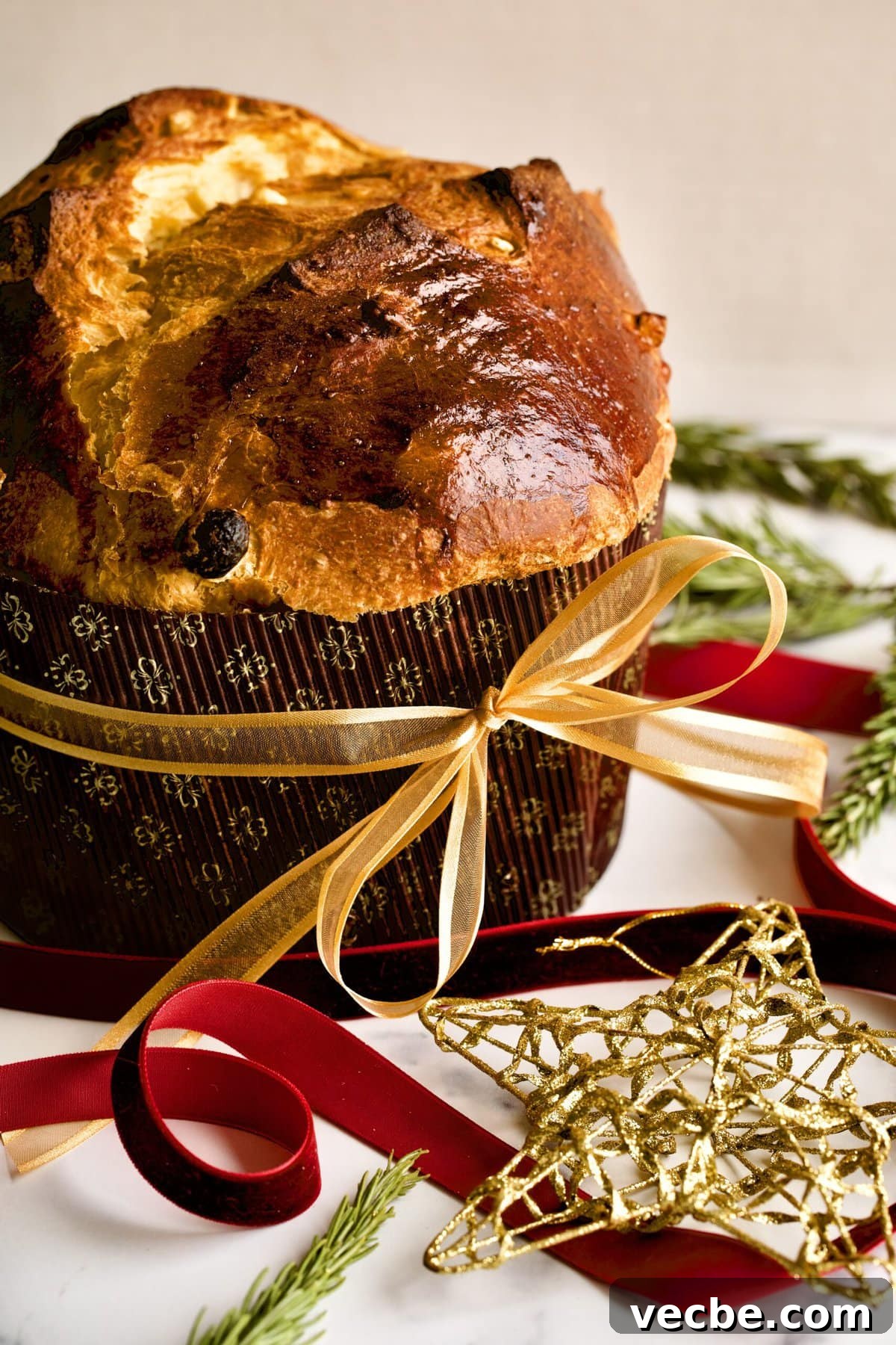 65+ Christmas Dessert Recipes Your Guests Will Love 18 traditional panettone top down of final cooked cake. Golden Christmas star in background.