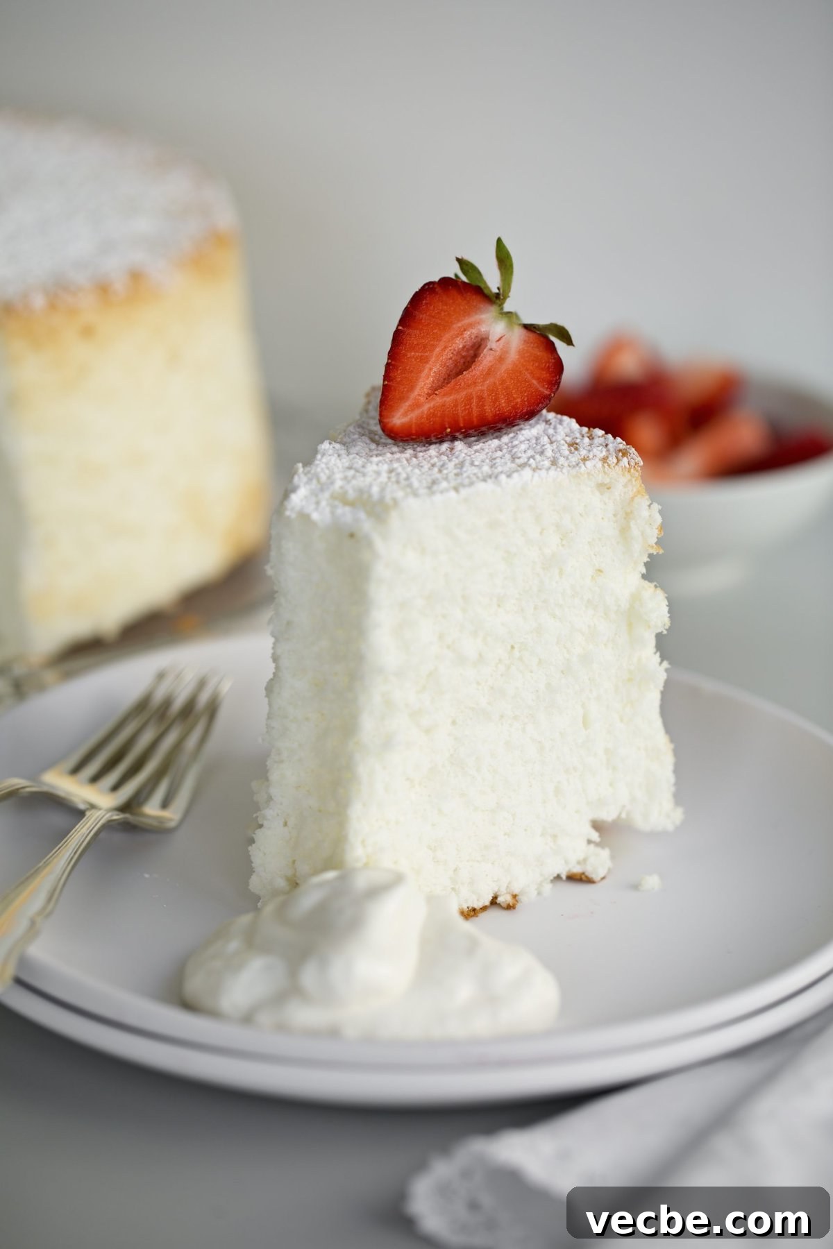 65+ Christmas Dessert Recipes Your Guests Will Love 21 angel food cake on a plate with strawberries