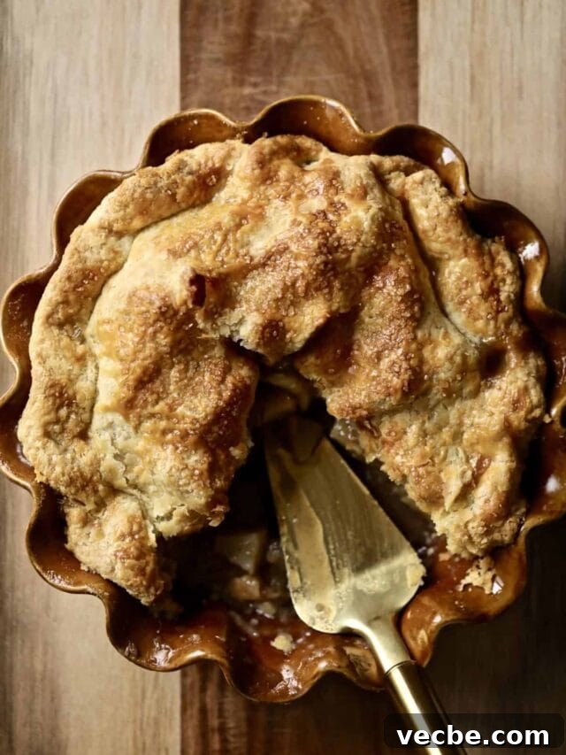 65+ Christmas Dessert Recipes Your Guests Will Love 38 Apple pie with pieces missing in a pin pan.