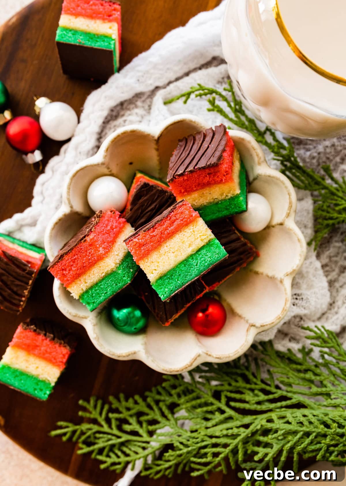 65+ Christmas Dessert Recipes Your Guests Will Love 5 plate of Classic Italian Rainbow Cookies Recipe with cute Christmas ornaments around the platter.