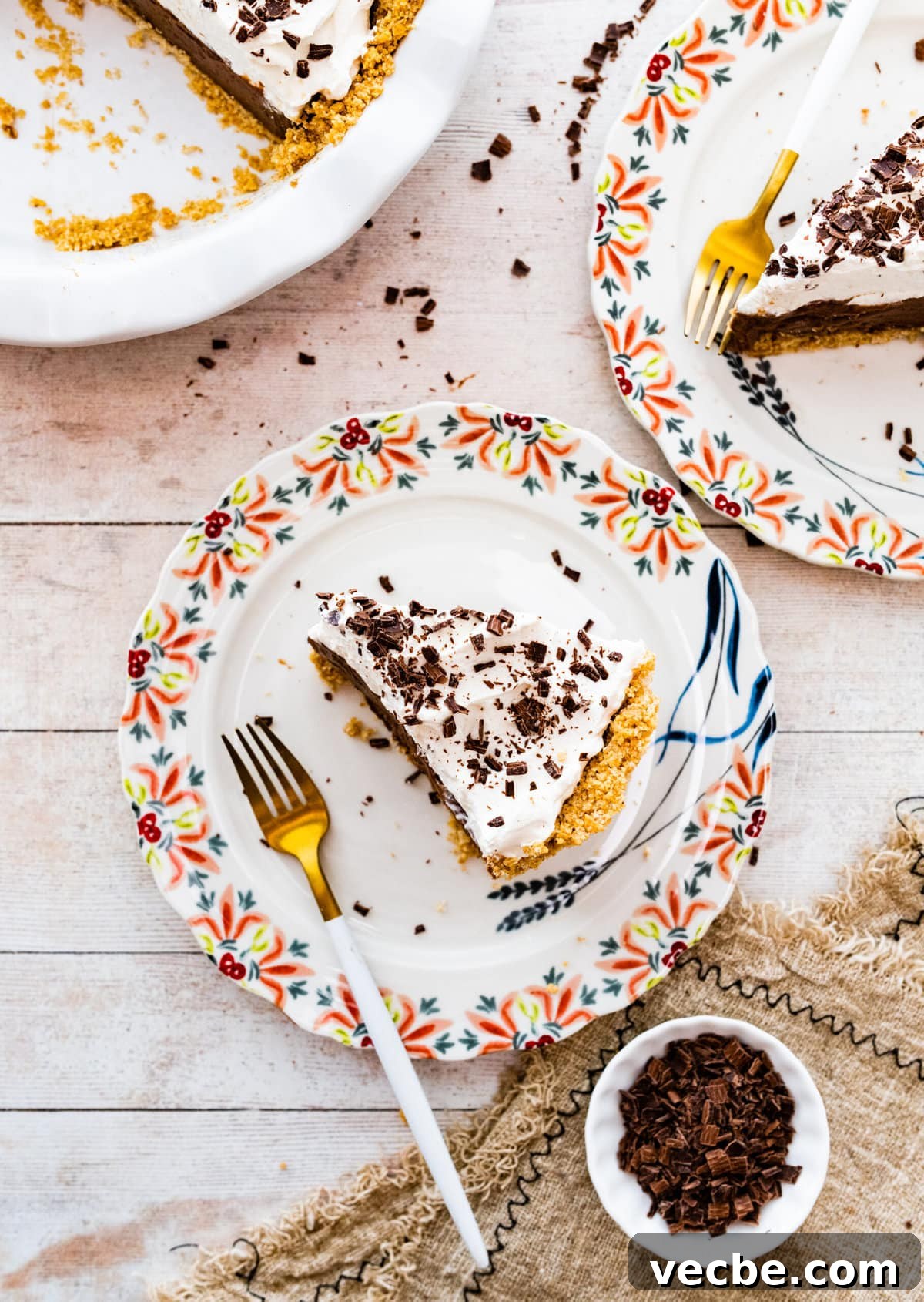 65+ Christmas Dessert Recipes Your Guests Will Love 44 slices of pie on a plates with pretty flower designed edges. Fork on plate.