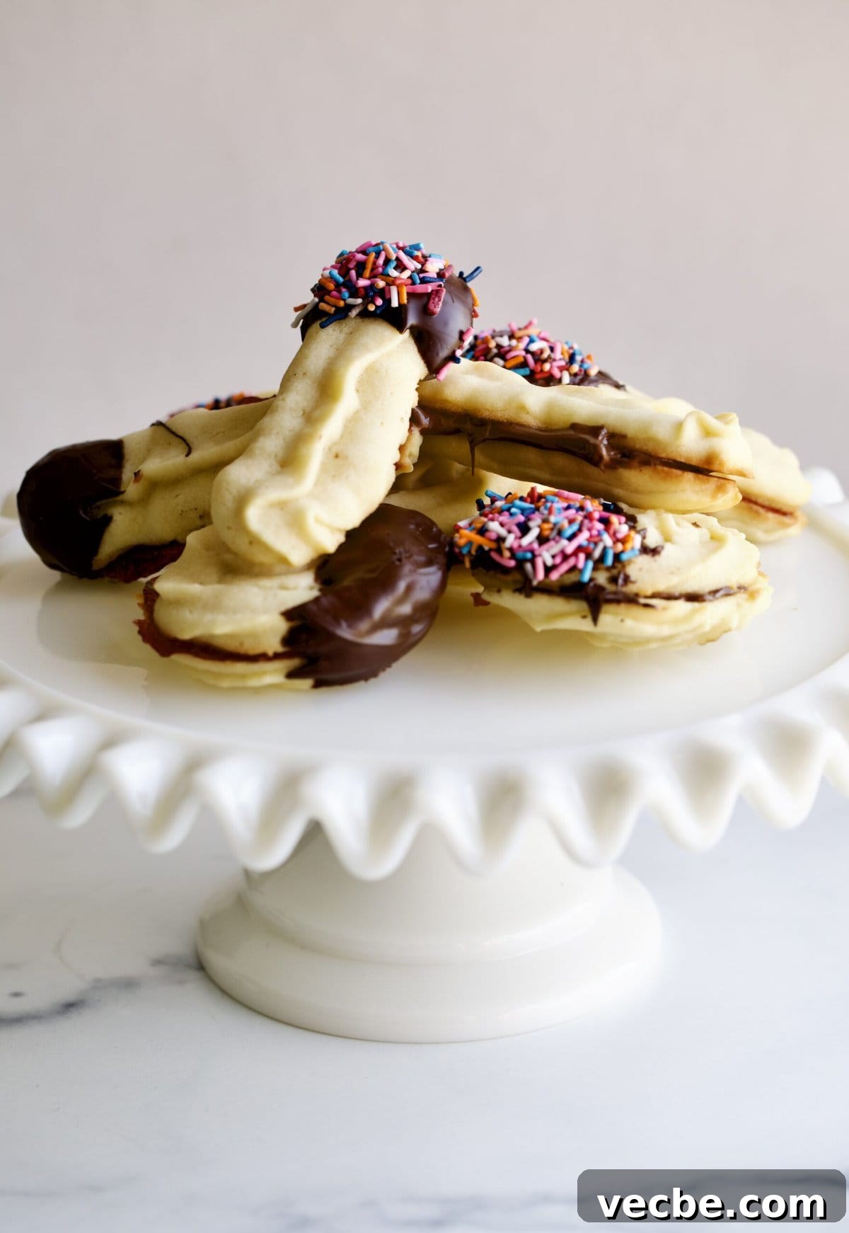 65+ Christmas Dessert Recipes Your Guests Will Love 7 Italian butter cookies on a cake platter.