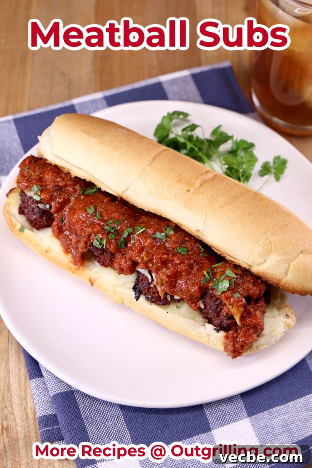 Meatball Subs with homemade marinara sauce are a quick and easy dinner to make on the grill. Meatball Marinara Sub Sandwich on a white plate with parsley garnish