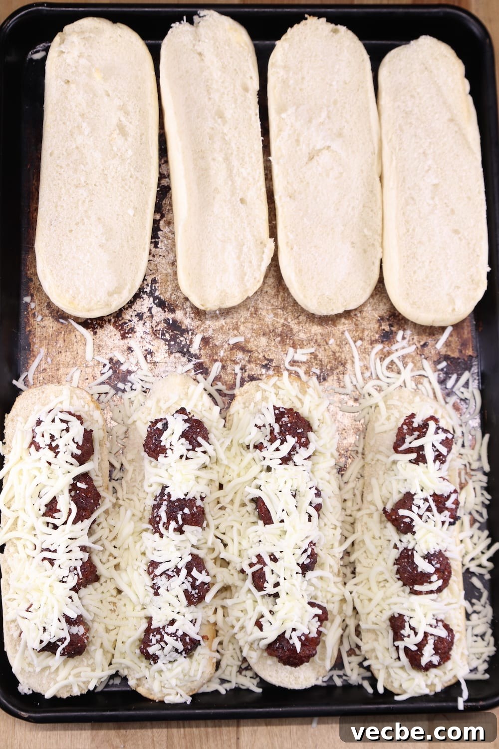 grilled marinara meatball subs Making meatball subs with shredded cheese on a sheet pan
