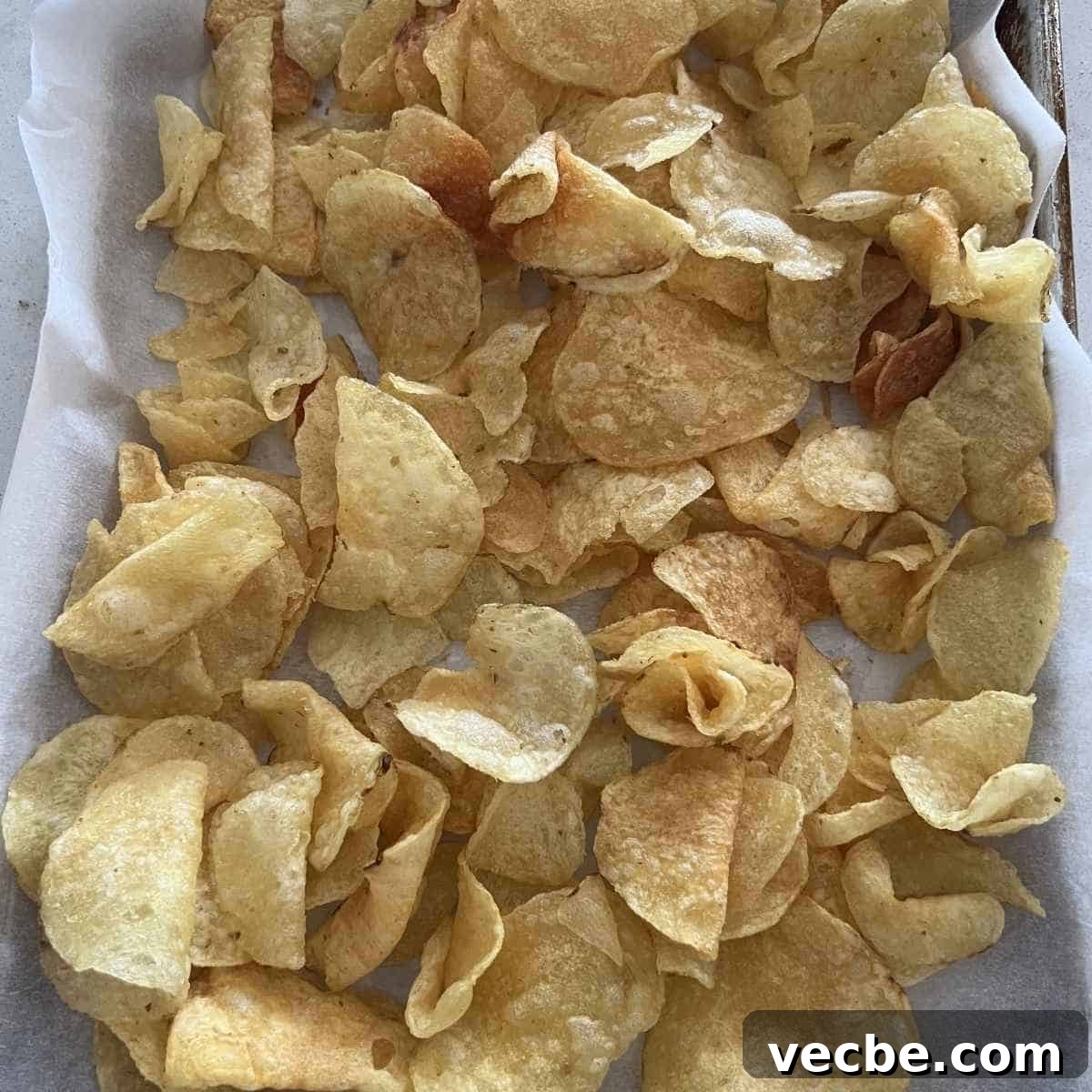 Loaded Charcuterie Nachos Appetizer 3 Kettle chips spread out on a pan.