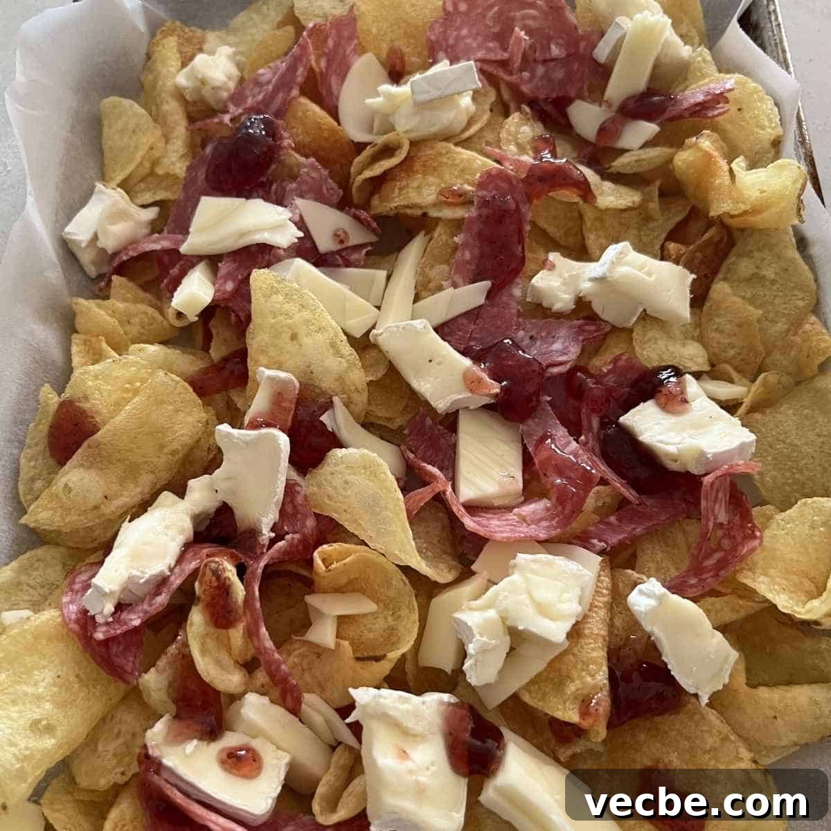 Loaded Charcuterie Nachos Appetizer 4 Cheese and salami on top of charcuterie nachos.