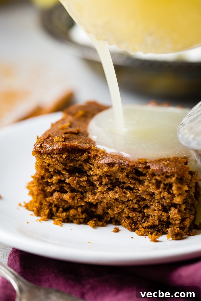 Warm Gingerbread Cake with Zesty Lemon Sauce 4 a warm slice of gingerbread cake with lemon sauce and a dollop of whipped cream