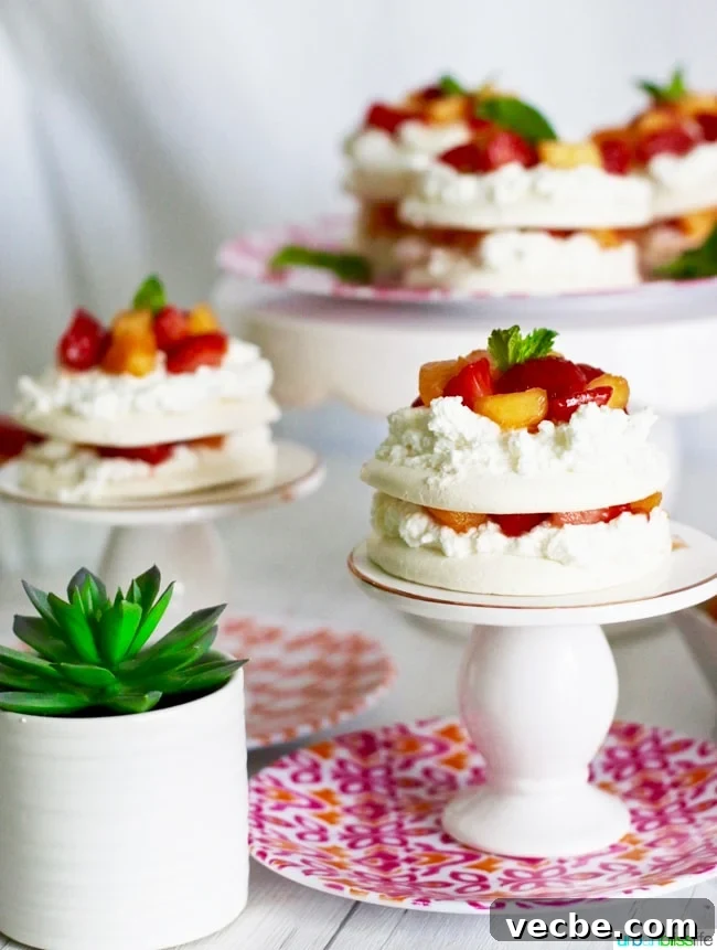 Summer Wine and Food Pairings for Warm Weather Meals 38 Mini Pavlova Cakes with Strawberries, Peaches, and Cream recipe on UrbanBlissLife.com