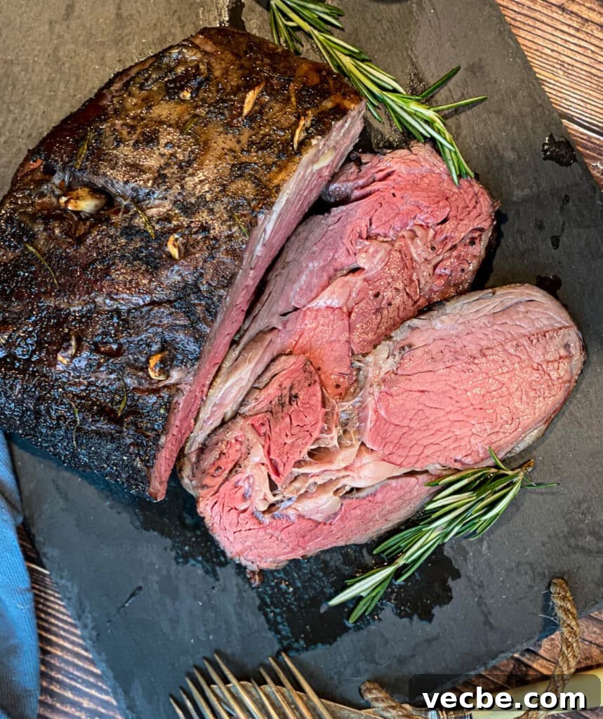 How to Smoke and Sear Prime Rib Roast 4 sliced smoked prime rib recipe on a cutting board