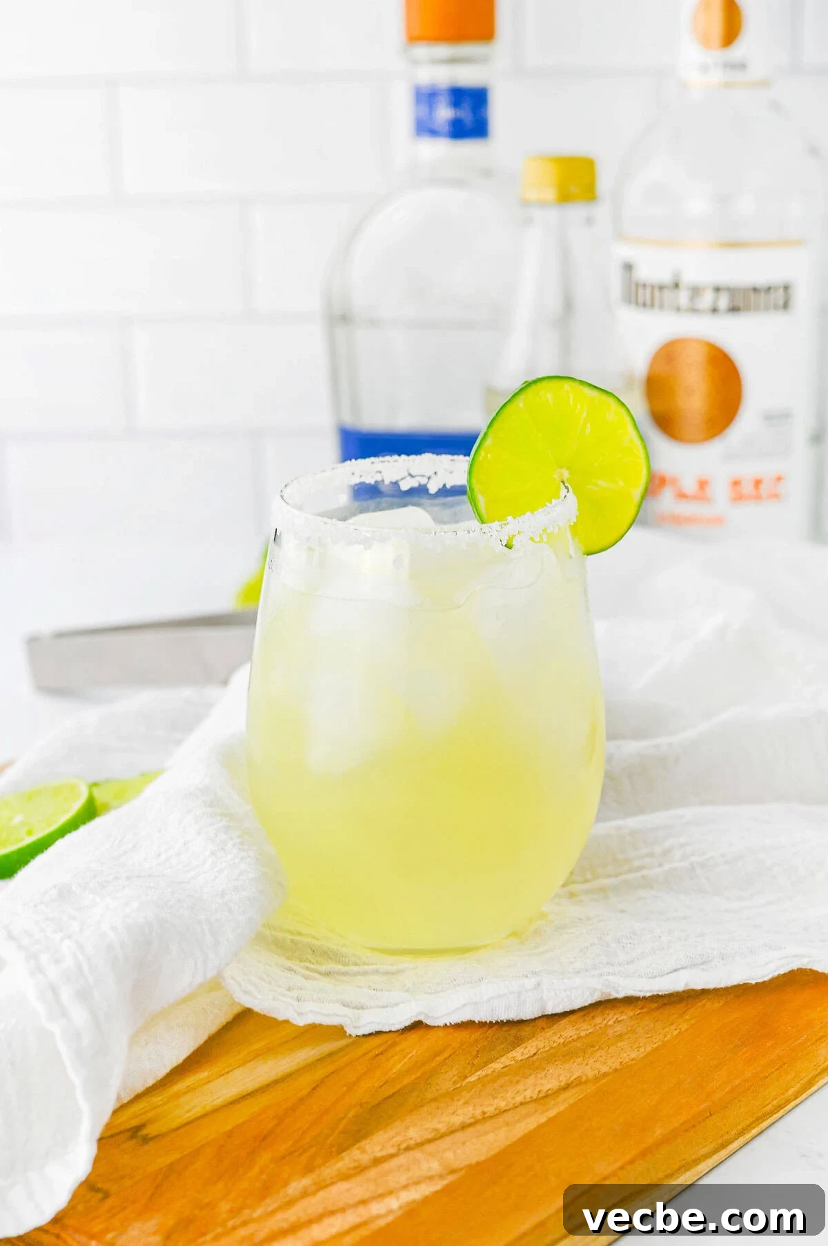 Authentic Lime Margarita Recipe with Fresh Lime Juice 2 Lime Margarita in a glass on wooden board