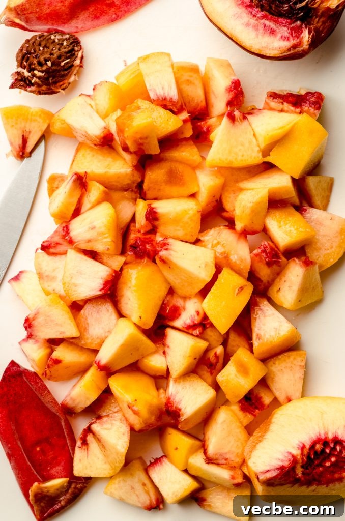 Peach Almond Streusel Muffins with Crumb Topping 14 Aerial photo of chopped peaches on a cutting board.