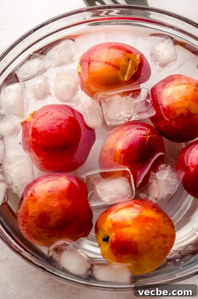 Peach Almond Streusel Muffins with Crumb Topping 7 Blanched peaches in a bowl of ice water.