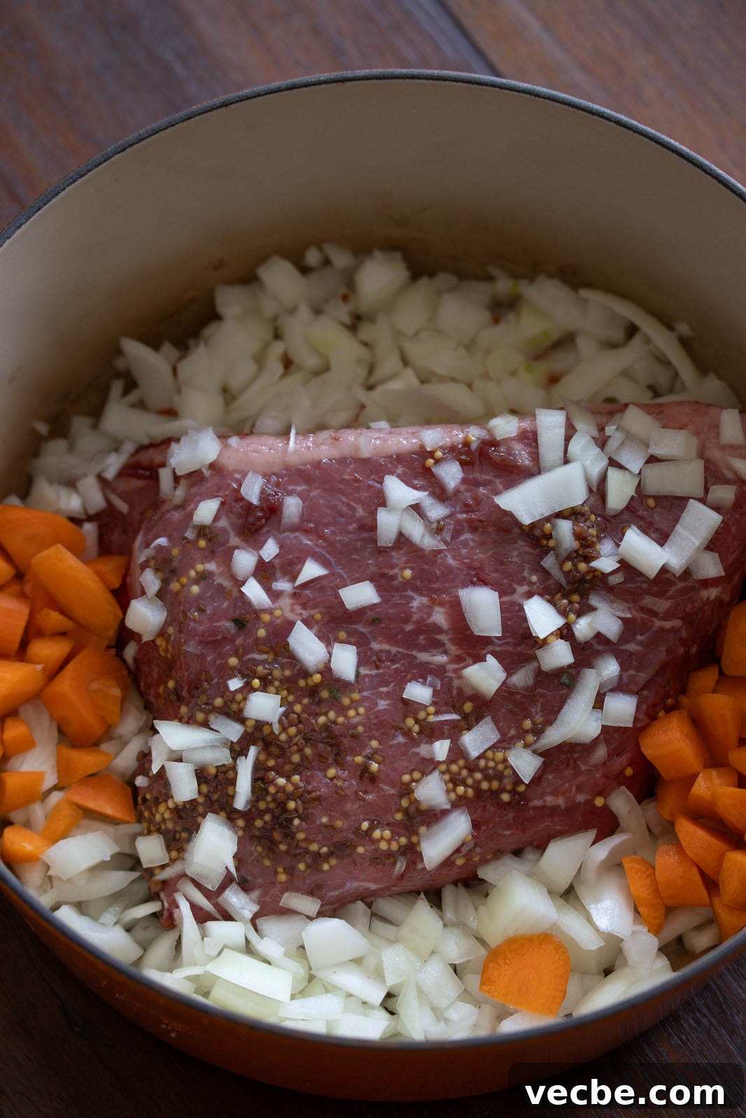 Pan-Seared Corned Beef with Parsley Cream Sauce 3 Corned Beef with Parsley Sauce in a dutch oven with carrots and chopped onions
