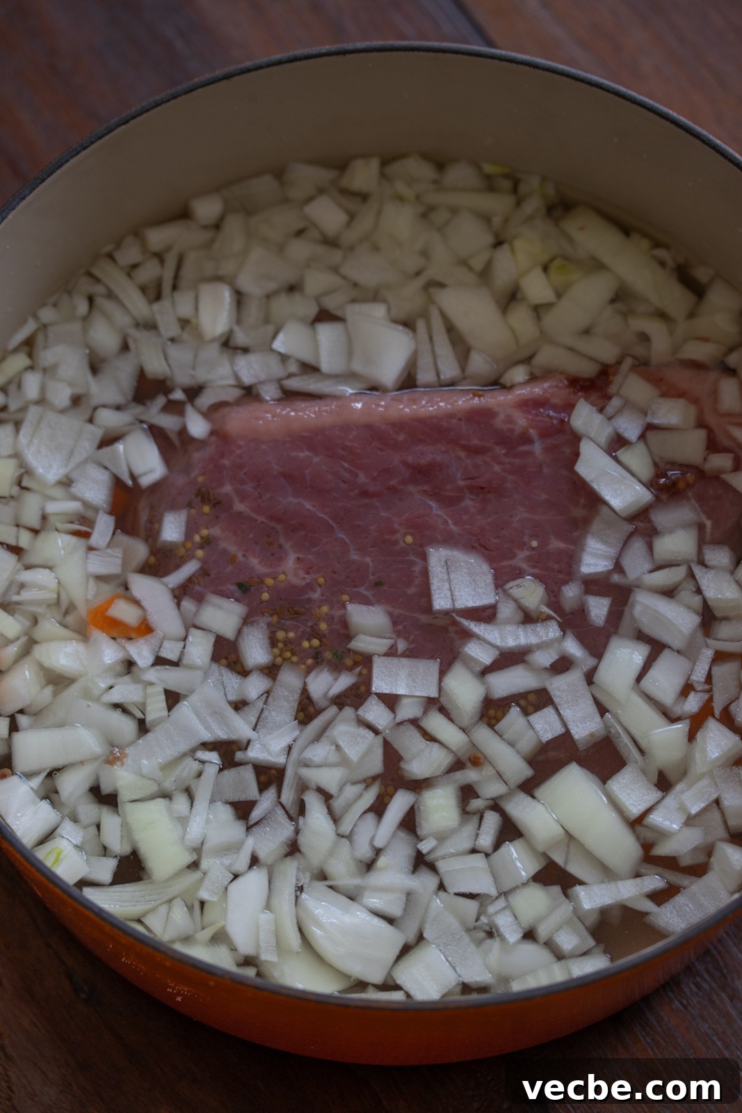 Pan-Seared Corned Beef with Parsley Cream Sauce 4 Corned Beef with Parsley Sauce in a dutch oven with carrots and chopped onions