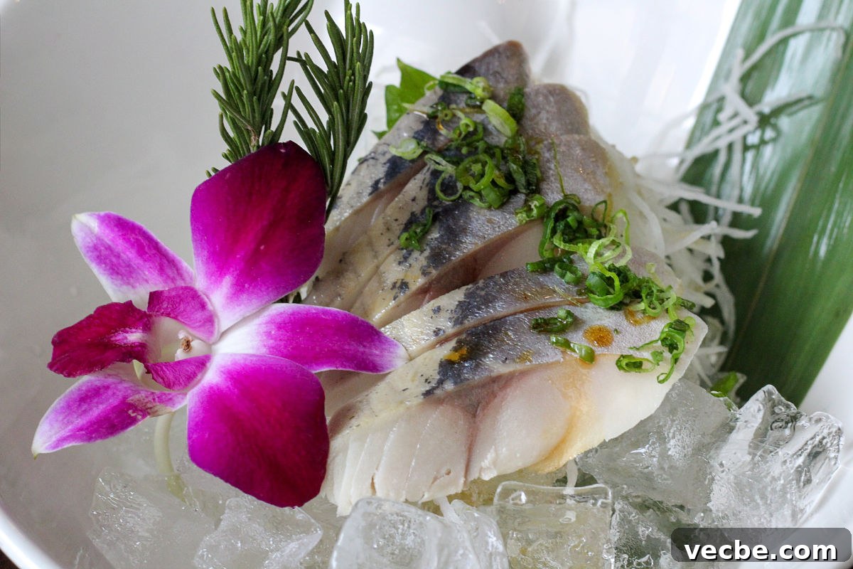 Edoko Sushi Richardson Review with Menu Highlights 5 5 pieces of mackerel sashimi served with a sprig of rosemary chopped scallions and edible flower at Edoko - photo by Kelly Kirkendoll