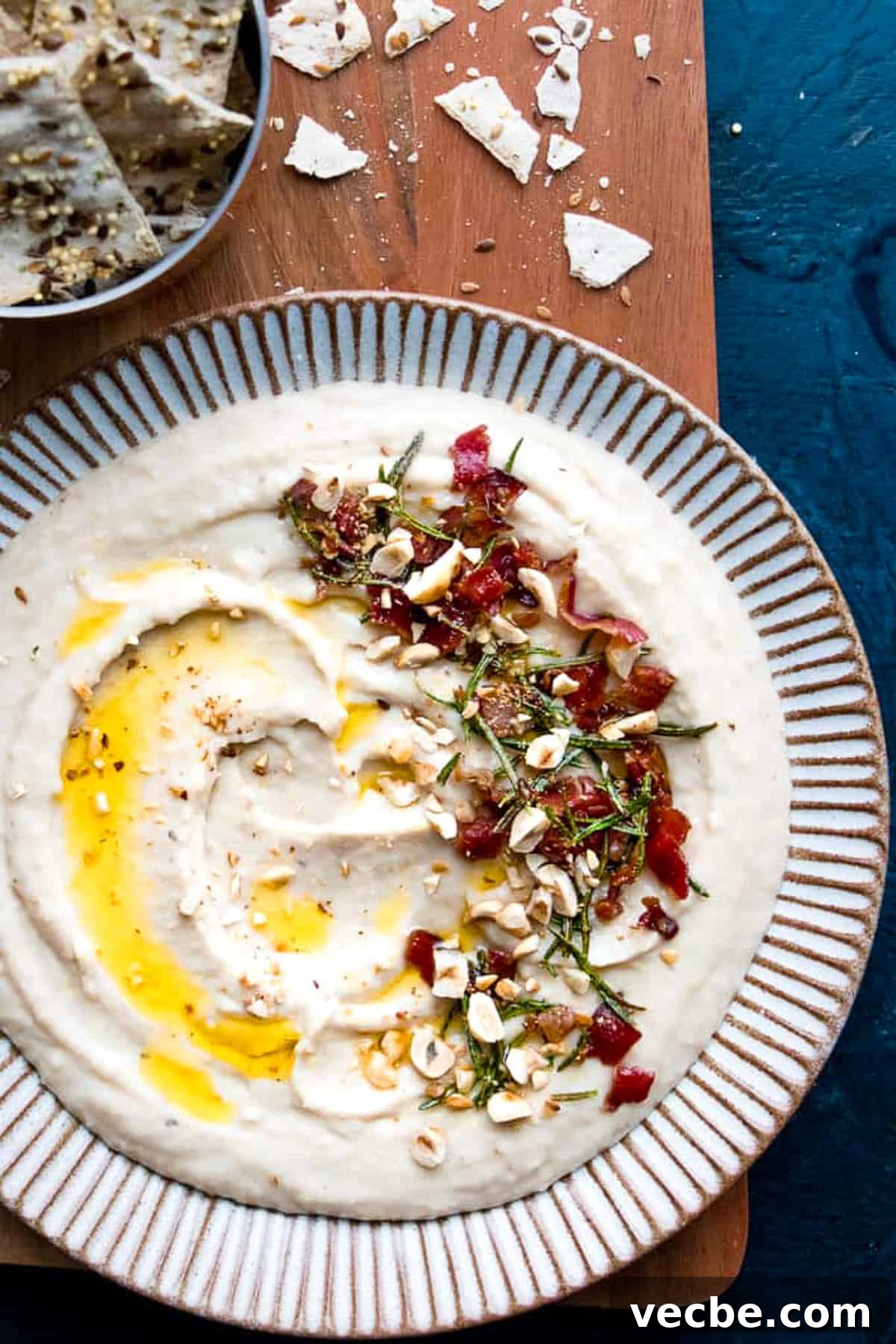 15 Minute White Bean Dip Recipe 2 Homemade creamy white bean dip on a plate drizzled with olive oil.
