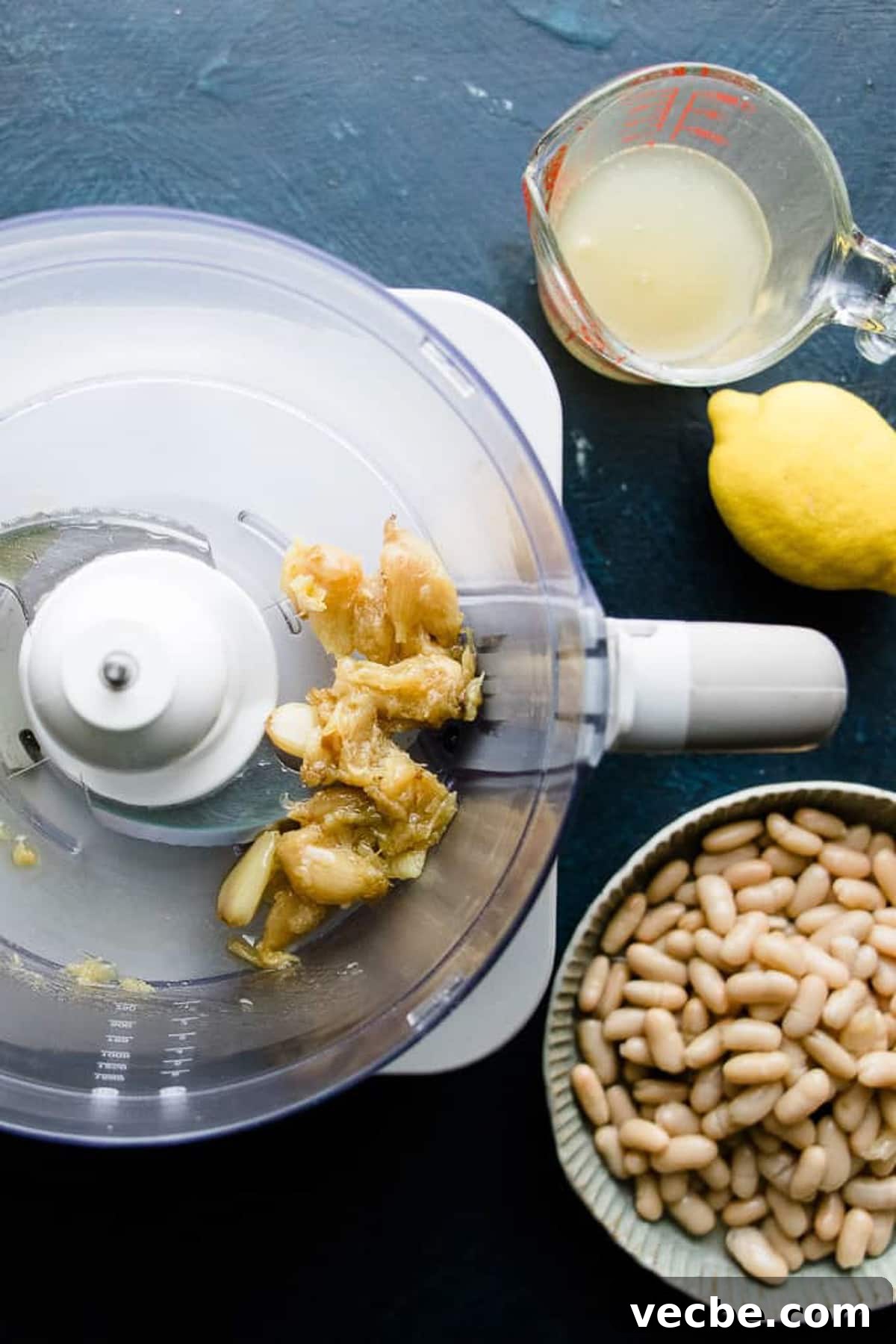 15 Minute White Bean Dip Recipe 3 Roasted garlic in a food processor for making white bean dip.