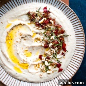 15 Minute White Bean Dip Recipe 5 Homemade creamy white bean dip on a plate drizzled with olive oil.