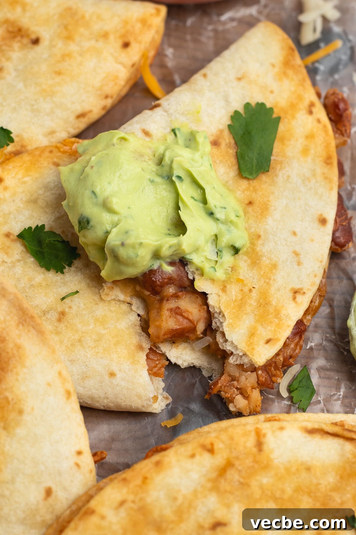 Crispy Baked Bean and Cheese Tacos with Avocado Crema 3 This is a close-up picture of a bean and cheese tacos with avocado crema.