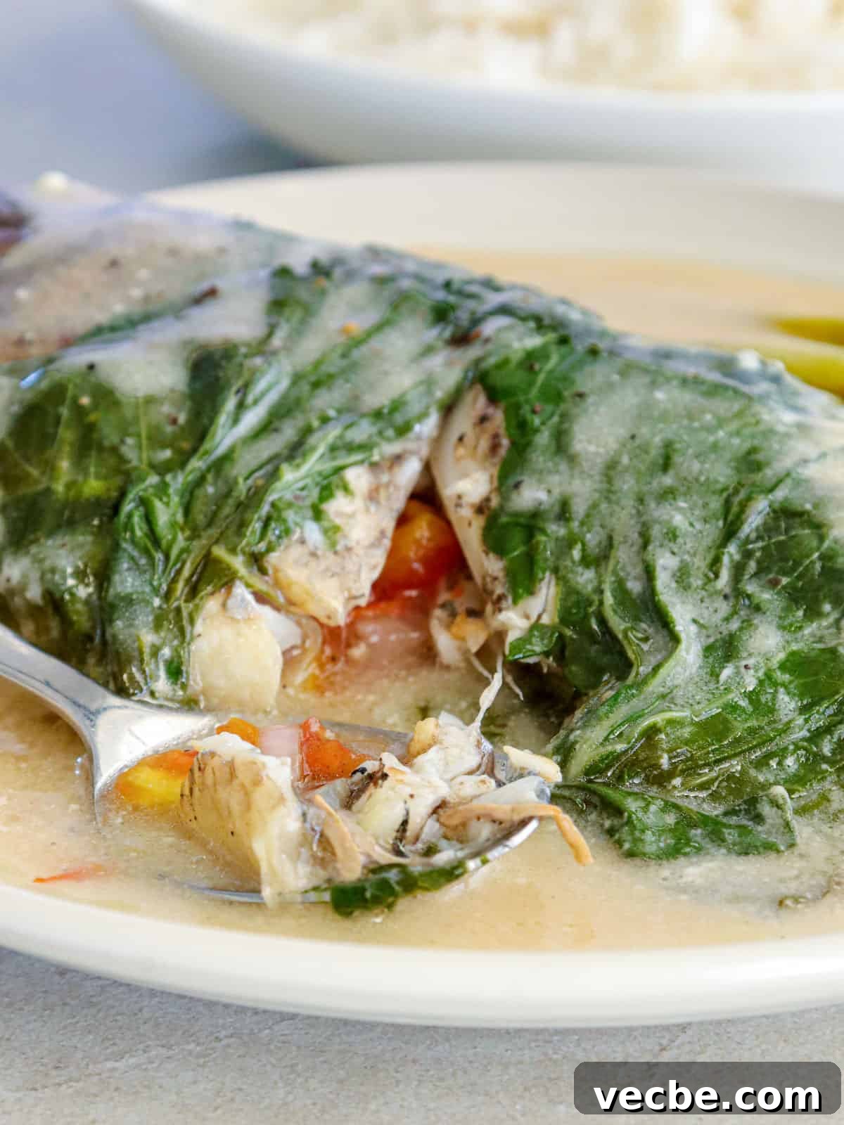 Sinanglay Tilapia: Filipino Coconut Milk Fish 5 Eating Sinanglay na Tilapia with a fork.