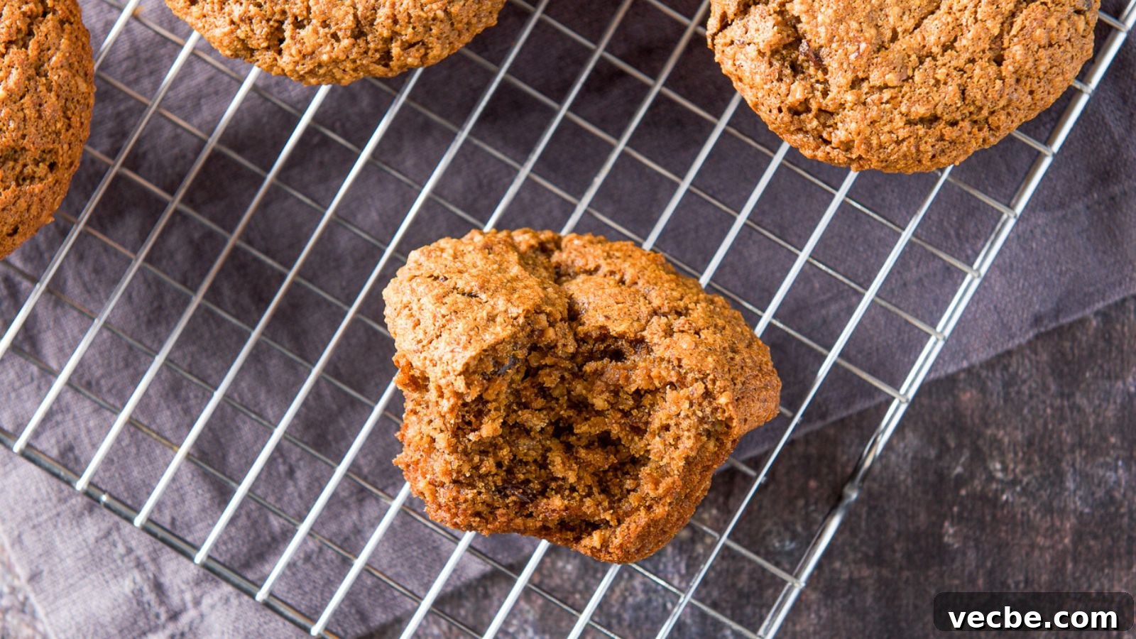 Moist Raisin Oat Bran Muffins Recipe 3 overhead view of muffins on a wire rack with a bite taken out of one of them