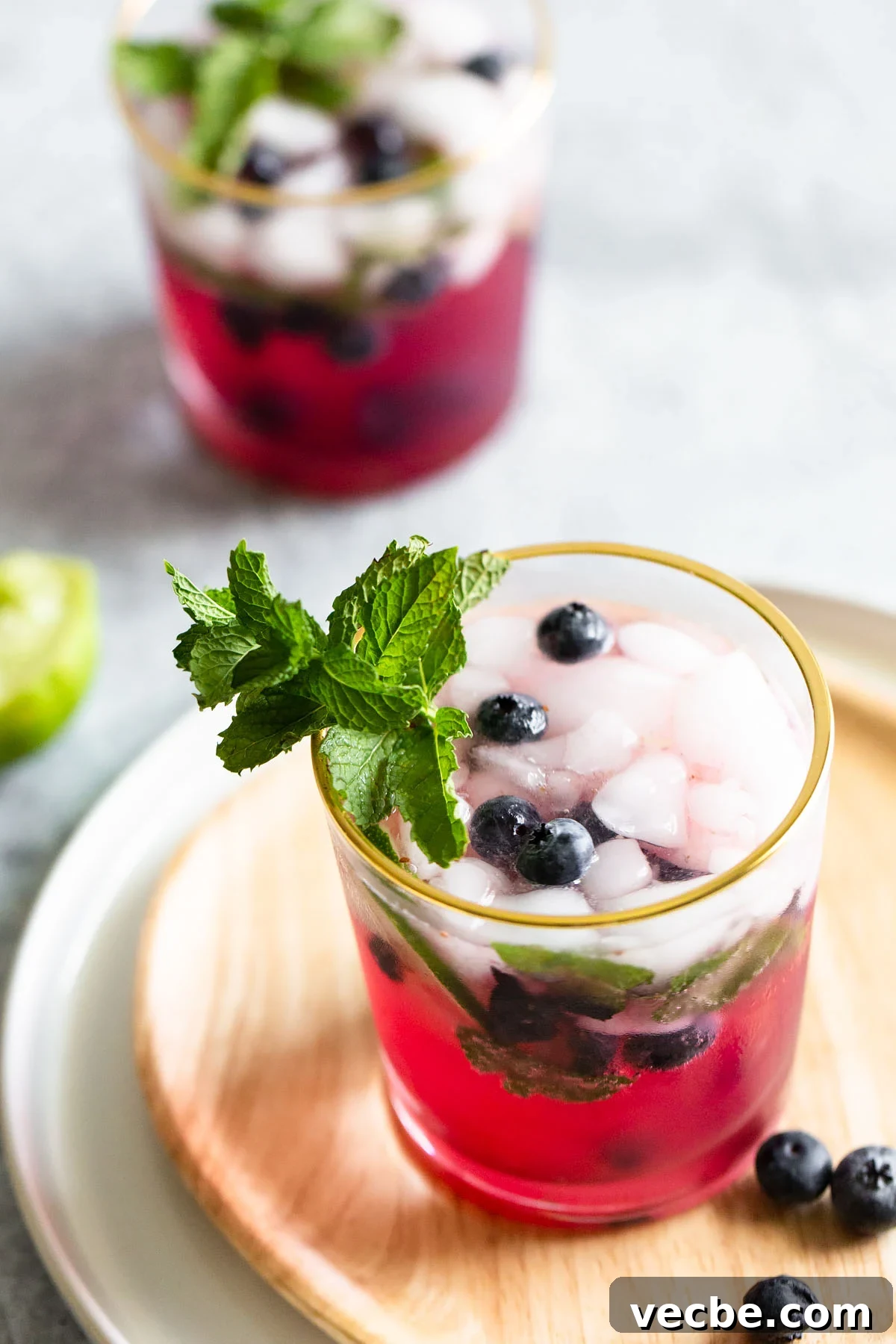 Holiday Mocktail Recipes for Festive Gatherings 5 blueberry mojito mocktail with fresh blueberries and mint
