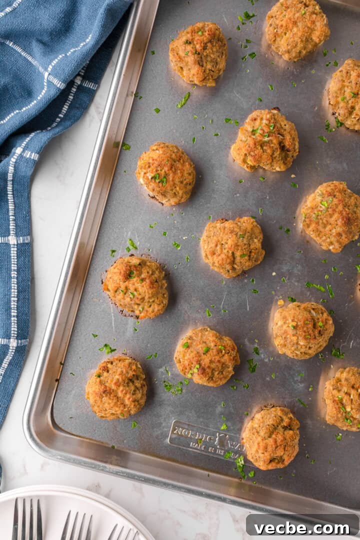 Baked Turkey Meatballs in Marinara Sauce 7 baked turkey meatballs on baking sheet.