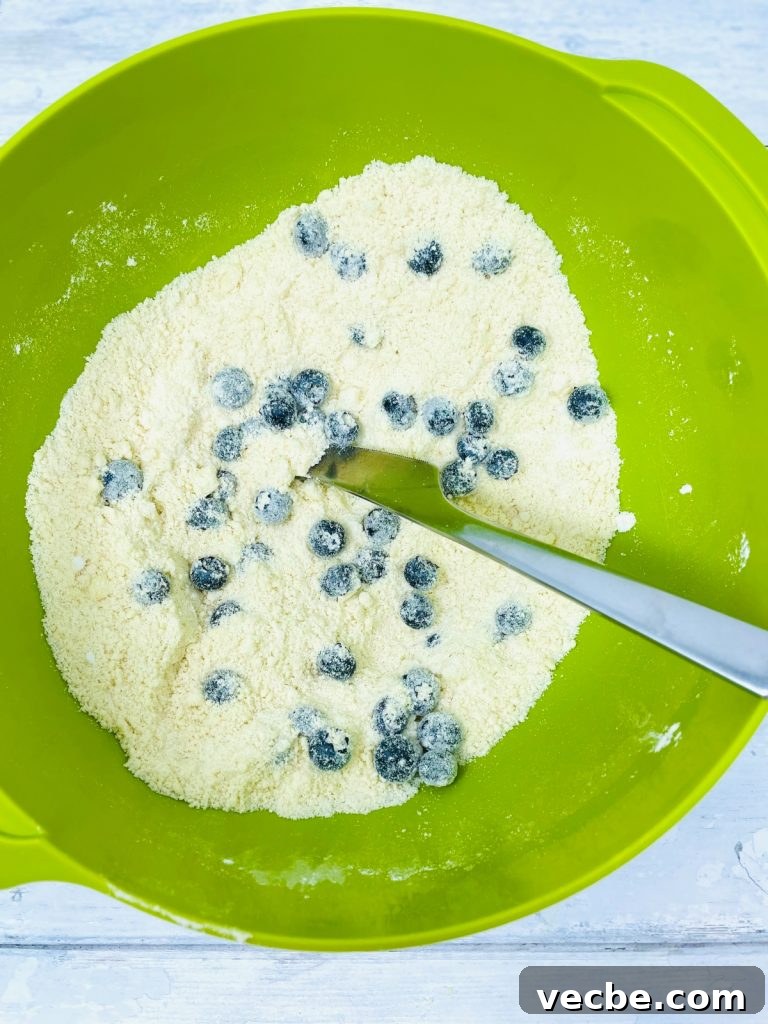 Buttery Blueberry Scones Recipe for Flaky, Tender Results 4 blueberry scone mixture in a green bowl