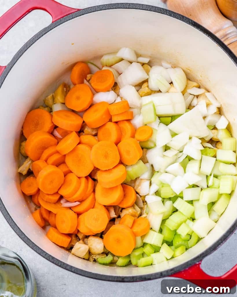 Creamy Chicken Gnocchi Soup Recipe 6 Cooking vegetables in a large pot.