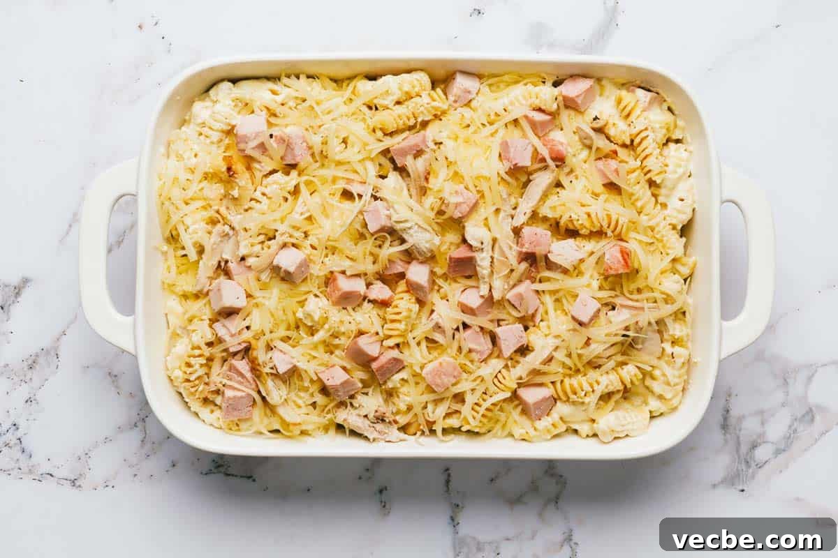 Creamy Chicken Cordon Bleu Casserole Recipe 6 Baking dish filled with homemade chicken cordon bleu casserole topped with cheese.