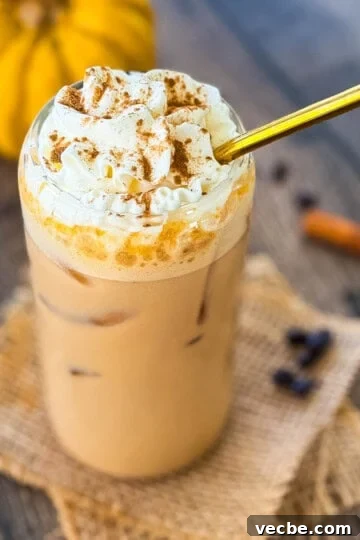 Pumpkin Pie Spice Recipe: Make 1 Tablespoon at Home 8 Glass of homemade iced pumpkin spice latte with ice cubes and whipped cream, surrounded by coffee beans and cinnamon sticks.
