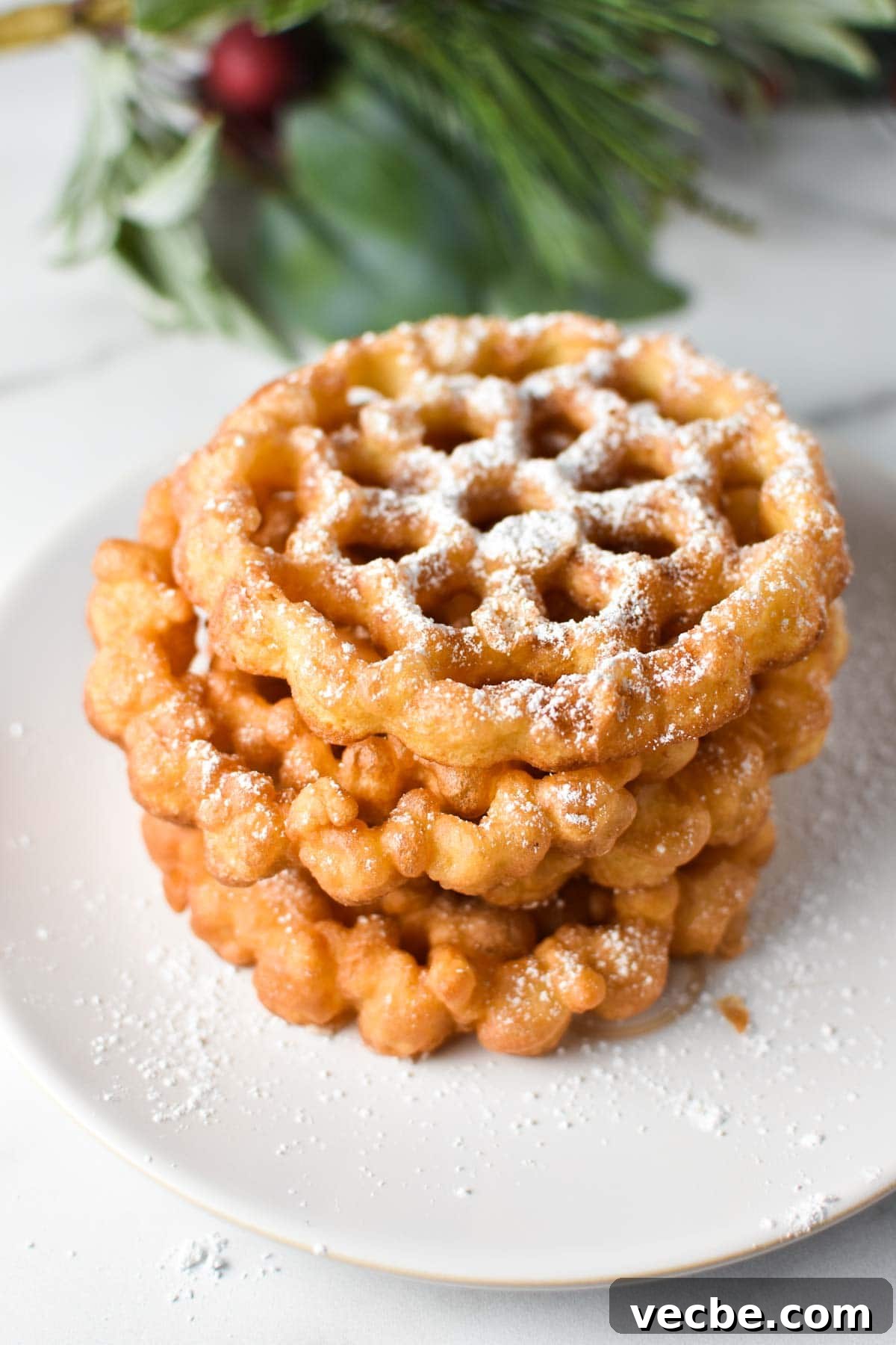 Crispy Rosette Cookies Recipe 2 A stack of fried cookies in a snowflake pattern
