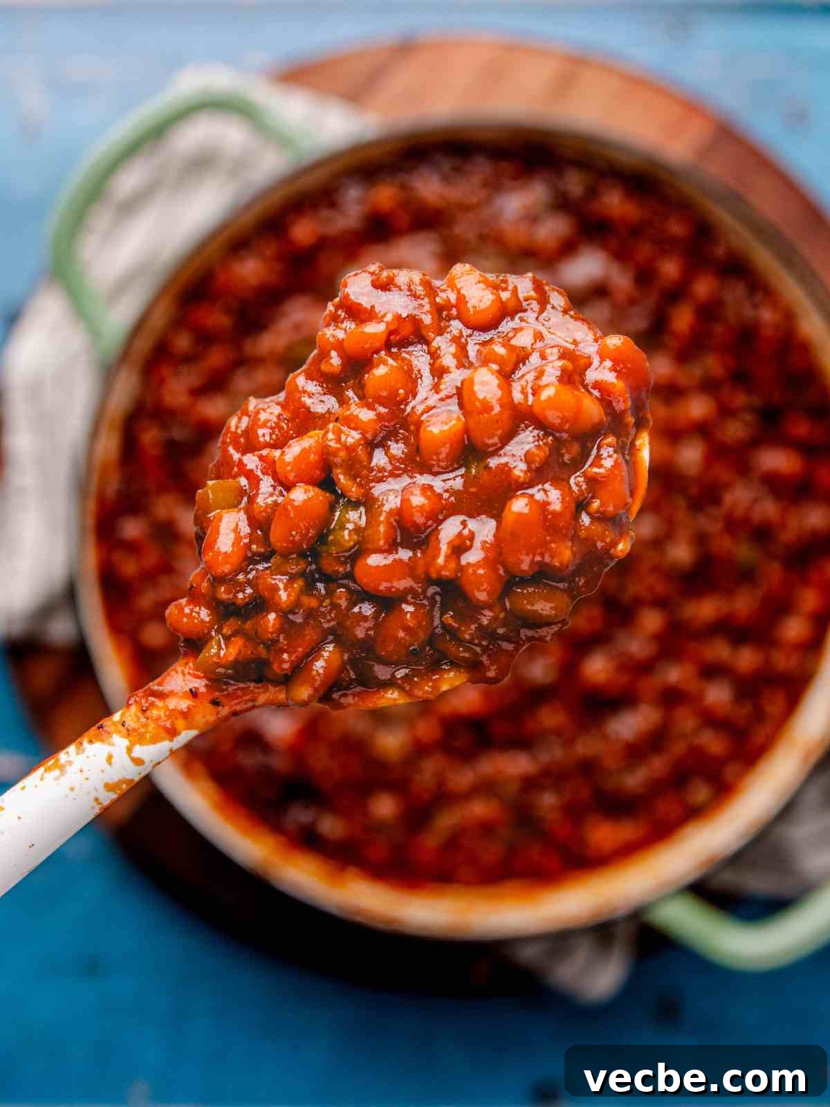 One-Pot Baked Beans with Ground Beef Recipe 4 A scoop of baked beans in a spoon.