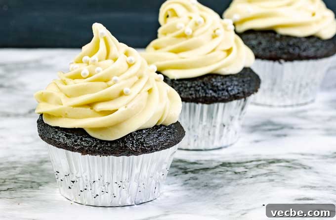 Guinness Dark Chocolate Cupcakes with Irish Cream Frosting 3 three Guinness Dark Chocolate Cupcakes with Irish Cream Cream Cheese Frosting in silver wrappers