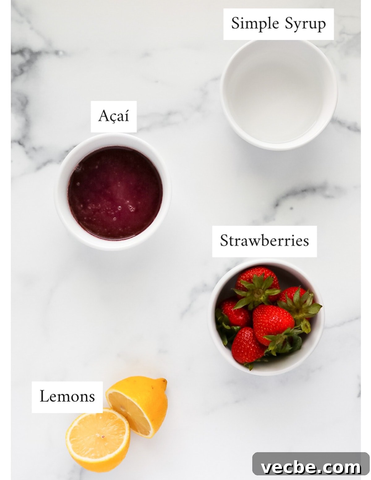 Strawberry Acai Lemonade Recipe 3 Labeled ingredients including: simple syrup, acai, strawberries, lemons