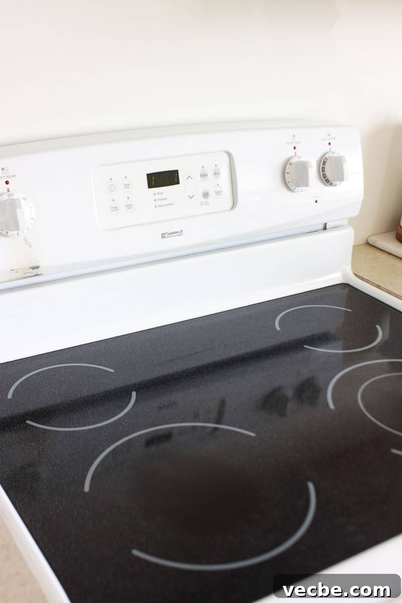 Remove Burn Marks from Glass Stovetop Without Scratching 2 a side view of an electric stove with a black glass top.
