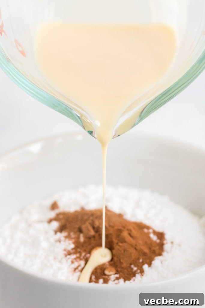 Soft Eggnog Cookies with Warm Holiday Spices 12 Eggnog being poured into a bowl to make eggnog glaze.