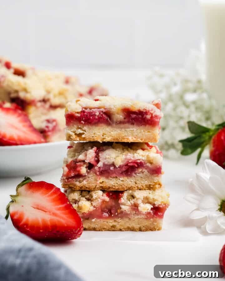 Three fresh strawberry bars stacked on top of one another.