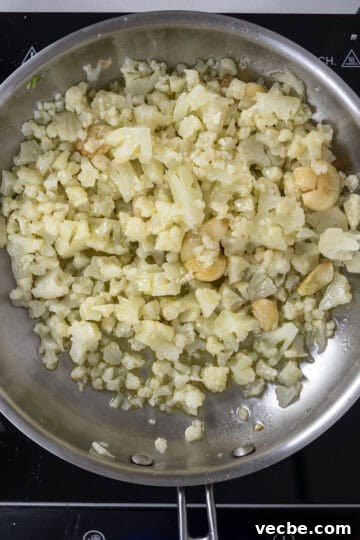 Roasted Cauliflower Pasta with Garlic and Parmesan 6 cauliflower added to saute pan with garlic.