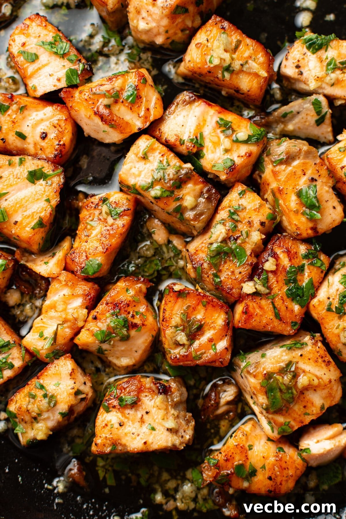 Pan-Seared Garlic Butter Salmon Bites Recipe 6 closeup of a skillet with garlic butter salmon bites