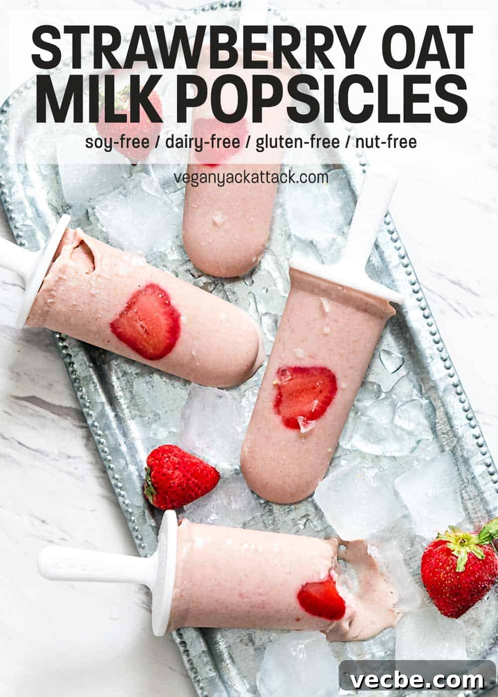 Creamy Strawberry Oat Milk Popsicles Recipe 2 Strawberry Oat Milk Popsicles on a metal platter with ice cubes
