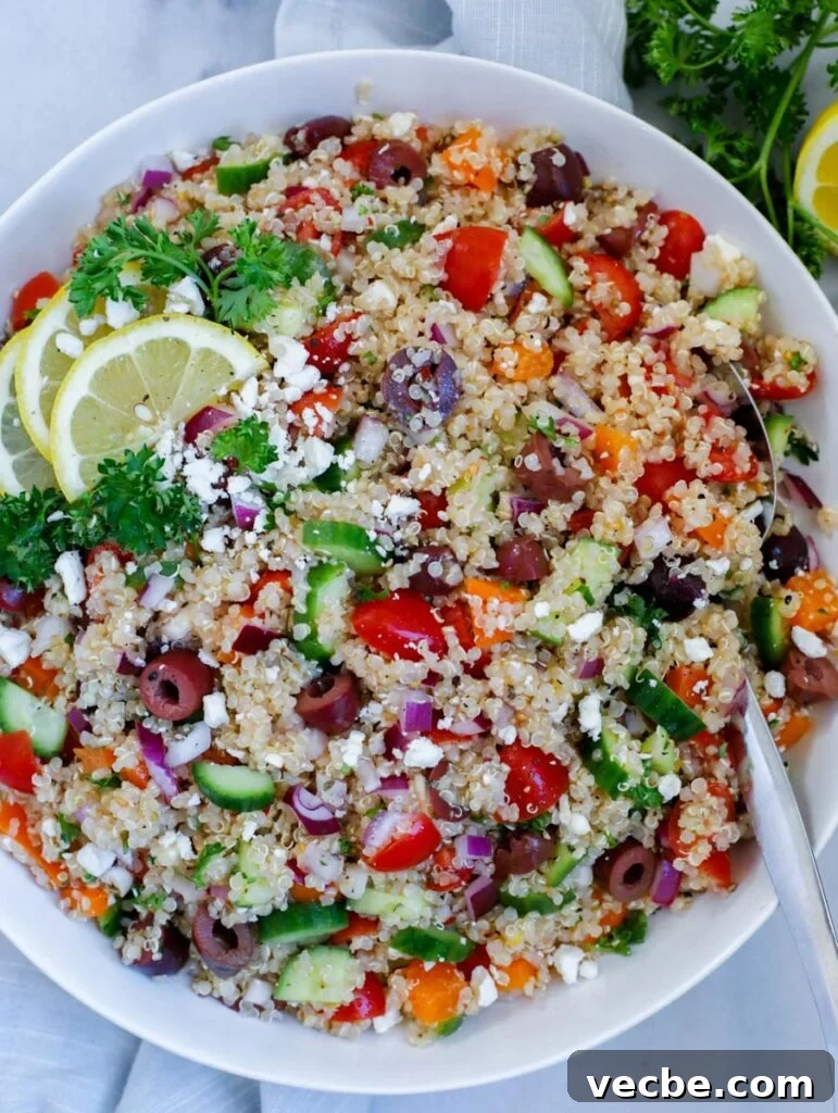 Mediterranean Quinoa Salad with Feta and Chickpeas 2 Mediterranean quinoa salad served in a dish, topped with feta cheese and lemon wedges