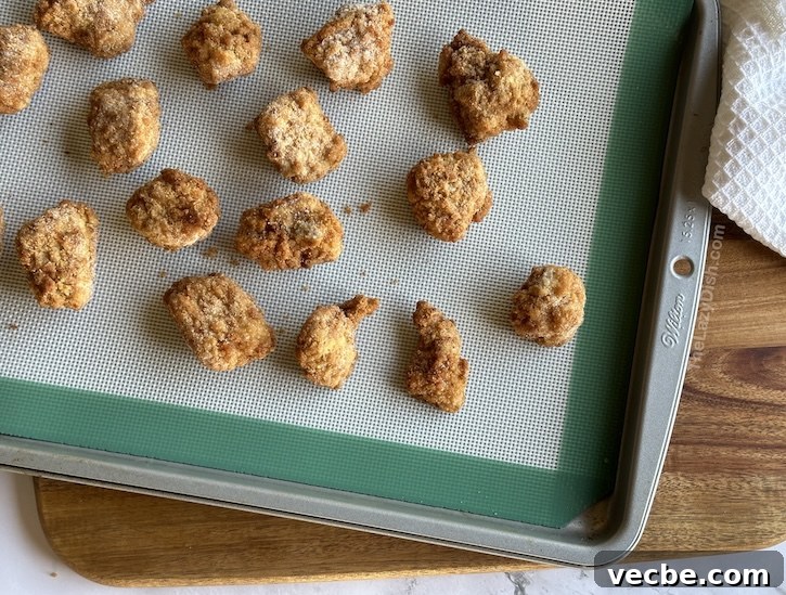 How to Make Copycat Chick-fil-A Chicken Minis 6 Frozen chicken nuggets on a baking sheet for making homemade Chick-fil-A chicken mini sandwiches, an easy copycat recipe for breakfast.