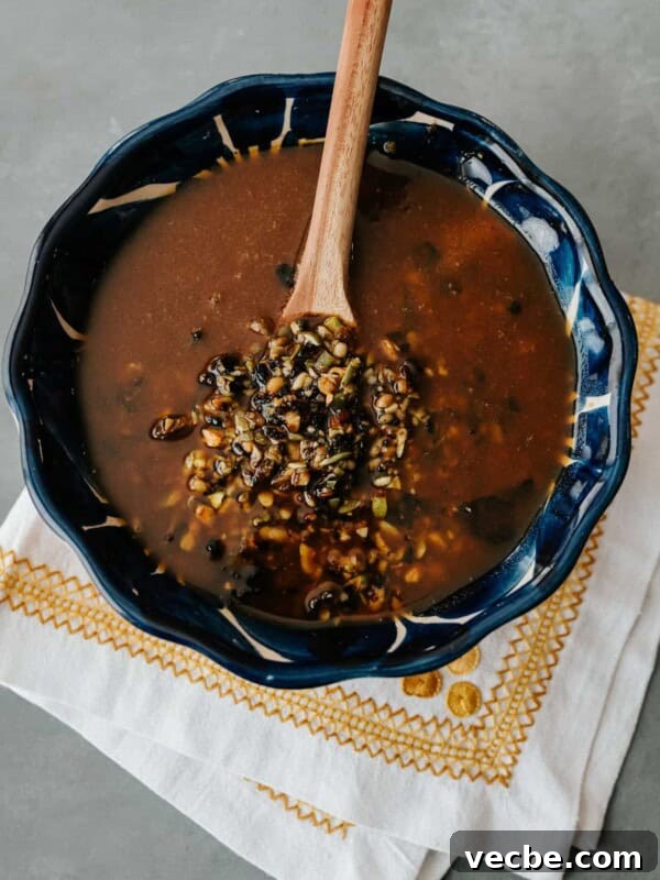 How to Make Mexican Chamoy Sauce at Home 13 salsa macha in a blue bowl with a wooden spoon.