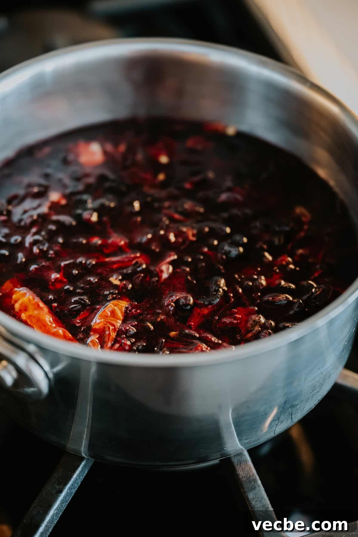How to Make Mexican Chamoy Sauce at Home 6 Homemade chamoy recipe by Yvette Marquez-Sharpnack of Muy Bueno simmering in a pot, a sweet, sour, and spicy Mexican chamoy sauce made with dried fruit, chiles, and lime.