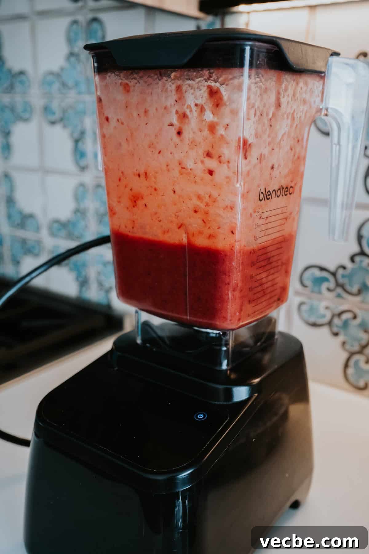 How to Make Mexican Chamoy Sauce at Home 8 Homemade chamoy recipe by Yvette Marquez-Sharpnack of Muy Bueno blended in a blender until smooth, with a colorful Spanish tile backsplash, showing a sweet, sour, and spicy Mexican chamoy sauce.