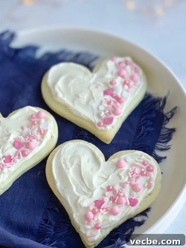 Romantic Valentine's Day Recipes for Two 10 3 heart shaped sugar cookies with white frosting and pink and white sprinkles on the right side of each cookie.