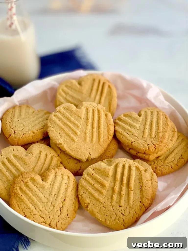 Romantic Valentine's Day Recipes for Two 3 Heart-shaped peanut butter cookies with the classic criss cross pattern on them on a platter.