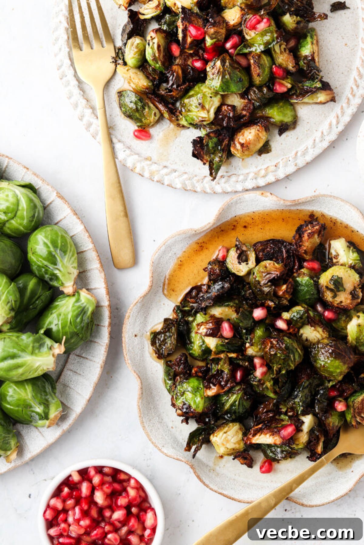 maple brussel sprouts 1.2 Balsamic maple brussel sprouts on plates with fresh pomegranate garnish.