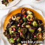Maple Balsamic Brussels Sprouts 6 maple brussel sprouts on a plate with pomegranate